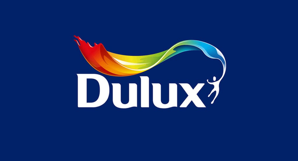 The Dulux logo on a blue background, featuring the word "Dulux" beneath a colorful paint swish transitioning from red to blue, highlights the brand’s expertise in exterior paintwork with a white figure appearing to paint the arc.
