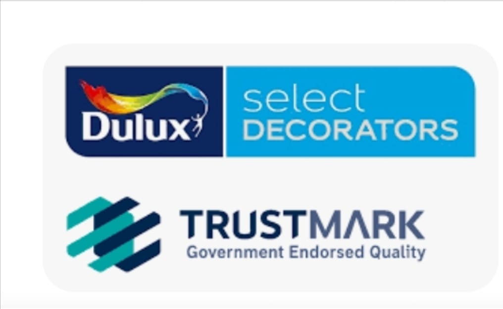 A graphic with two logos: "Dulux Select Decorators" featuring a multicolored swoosh, and "TrustMark Government Endorsed Quality" with a geometric teal design—ideal for painter and decorator or plastering professionals.